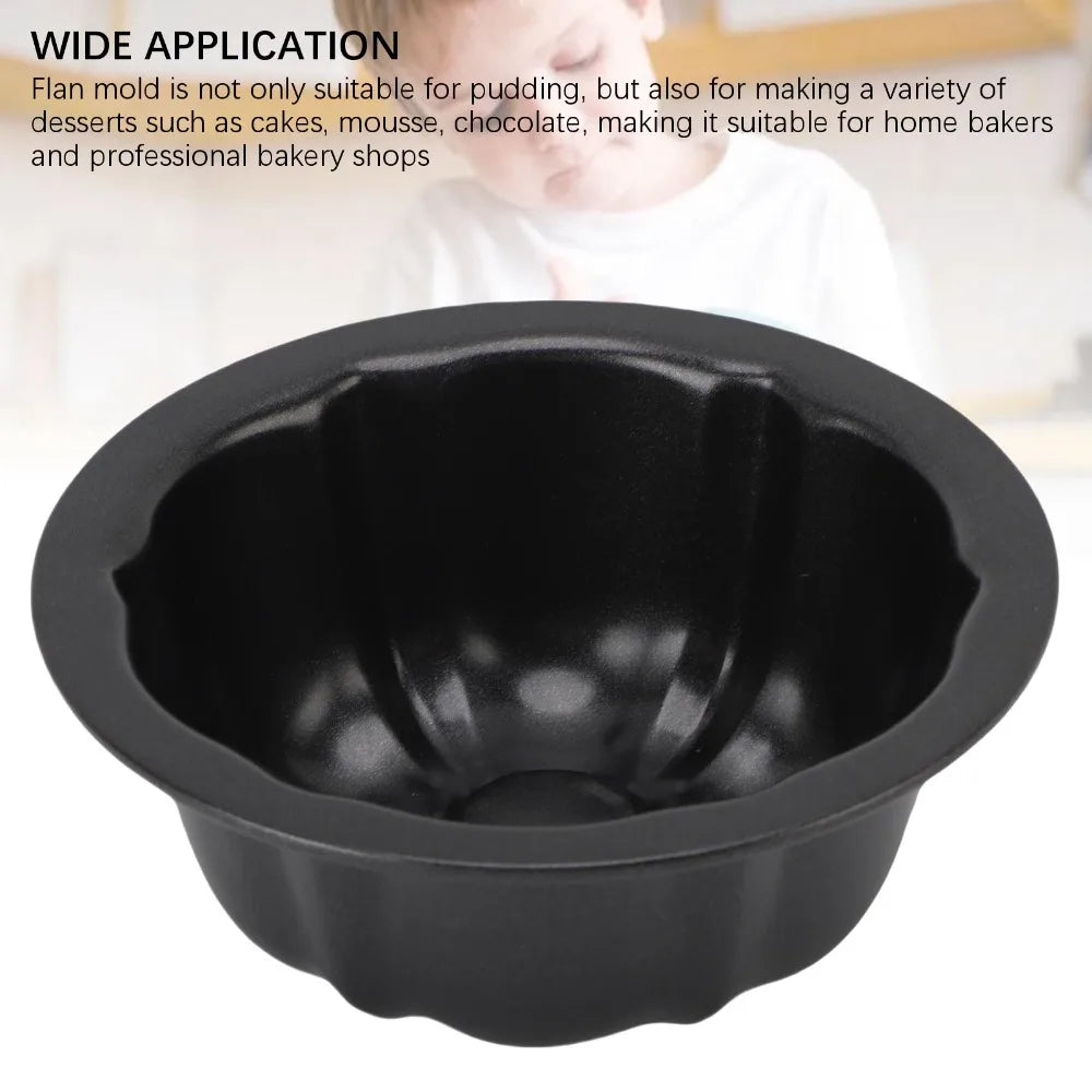 A black set of four nonstick mini fluted cake pans is shown against a light background.