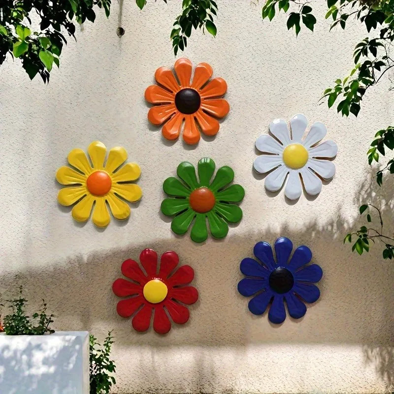 A collection of colorful iron sunflower wall art decor featuring orange, yellow, green, white, and blue flowers mounted on a 