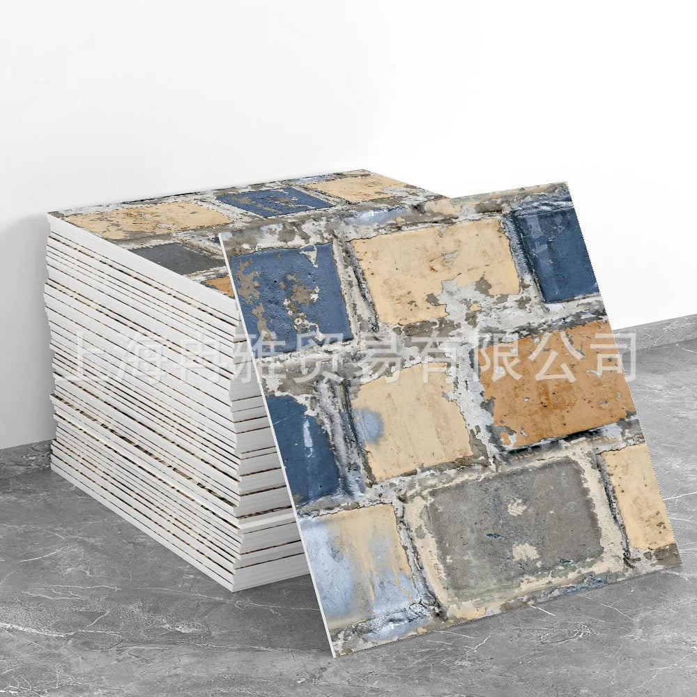 A stack of marble peel-and-stick tiles featuring blue and gold accents on a gray background.