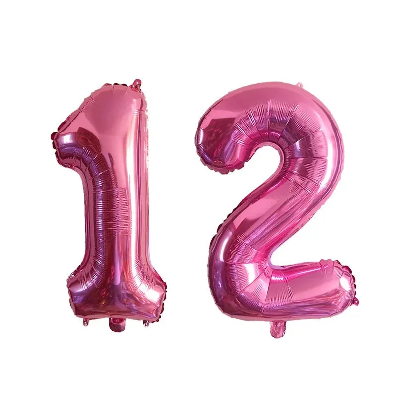 Two pink helium foil number balloons shaped like 1 and 2