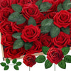 A close-up view of a dense arrangement of realistic red foam rose flower heads with green leaves.