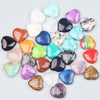 A collection of heart-shaped amethyst crystal stones in various shades of purple, pink, blue, and green.