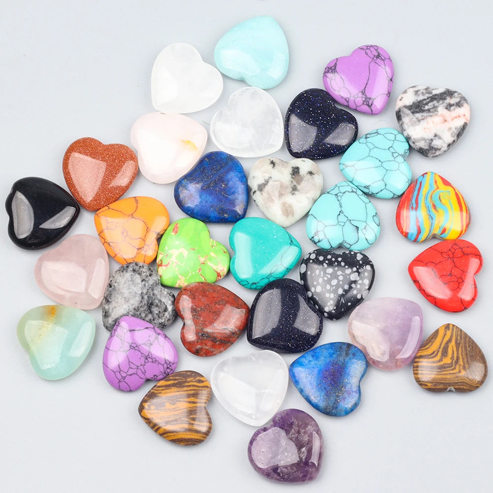 A collection of heart-shaped amethyst crystal stones in various shades of purple, pink, blue, and green.