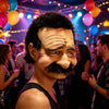 A person wearing a realistic old man horror mask with a prominent mustache and wrinkled skin at a party.