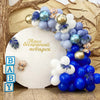 A large balloon bouquet featuring blue, white, and purple latex balloons for a baby shower or party.