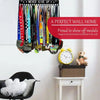 A wall-mounted metal display rack featuring various medals and a sign that reads Never Give Up