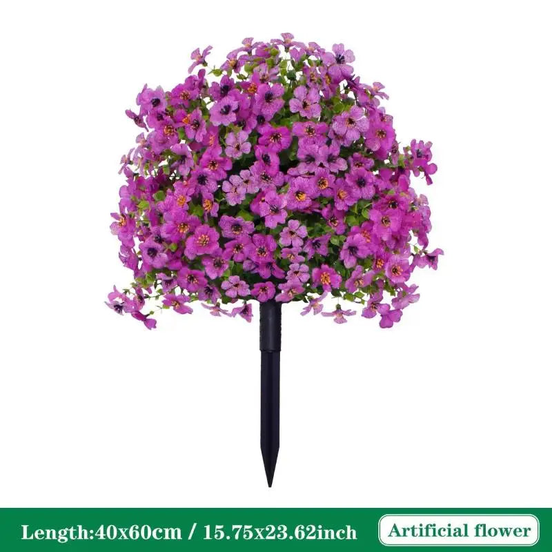 A dense cluster of vibrant purple artificial petunias on a black ground stake.