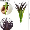A tall, green artificial grass plant with dark purple leaves is shown in a close-up view.