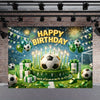 A festive soccer field backdrop for a birthday celebration featuring a large soccer ball surrounded by balloons and greenery.