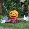 An inflatable orange pumpkin decoration with a carved face and a plaid shirt costume.
