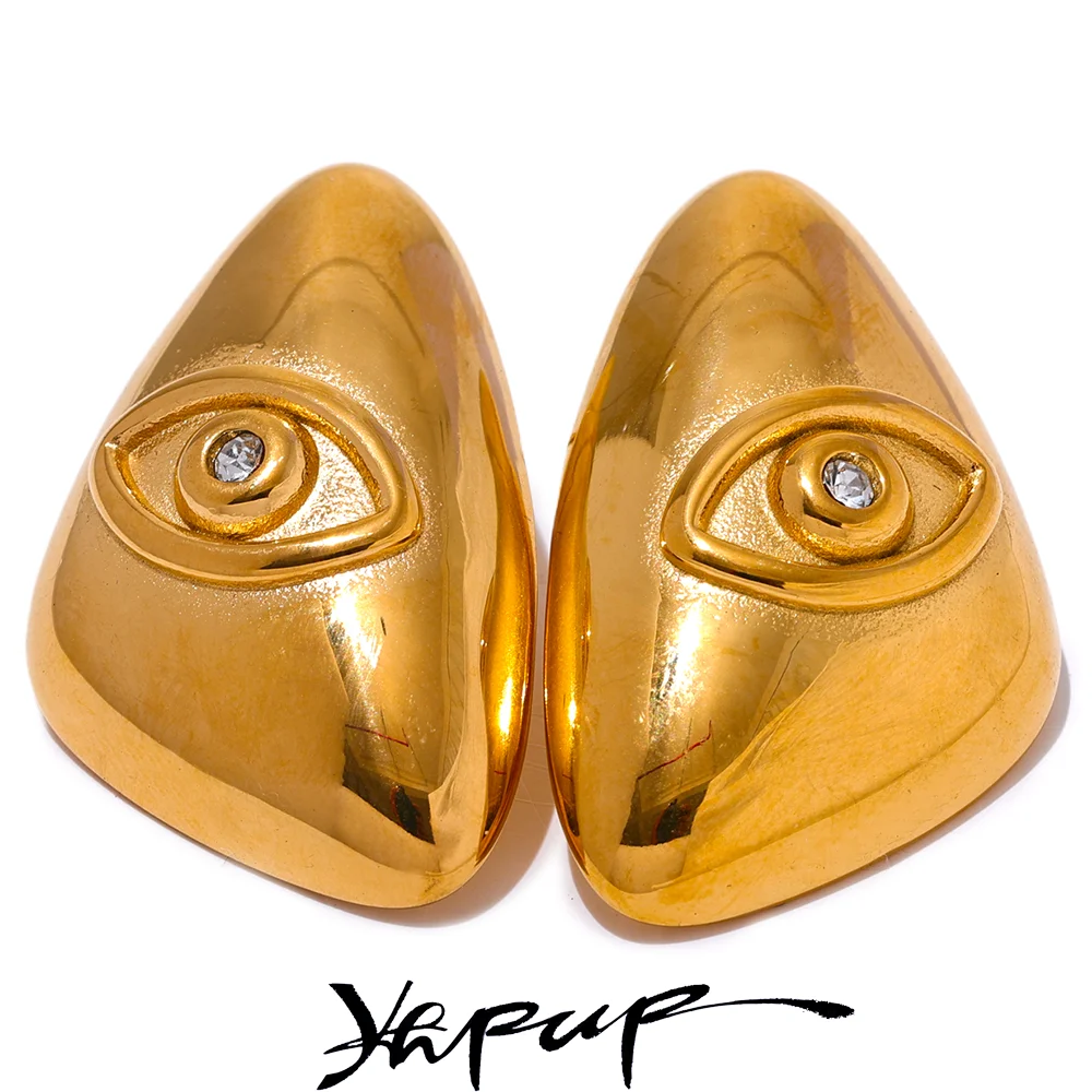 A pair of gold-colored geometric stud earrings shaped like eyes.