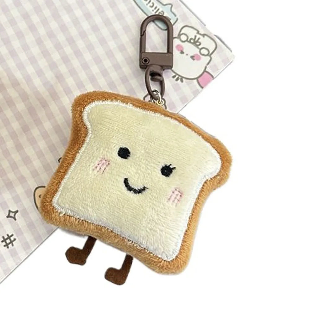 A soft, light yellow toast bread shaped plush charm attached to a metal keychain ring.