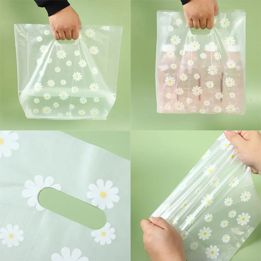Clear plastic gift bags with daisy print designs being held by hands.