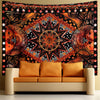 Bohemian sun and moon tapestry wall hanging featuring warm orange, black, and gold patterns.