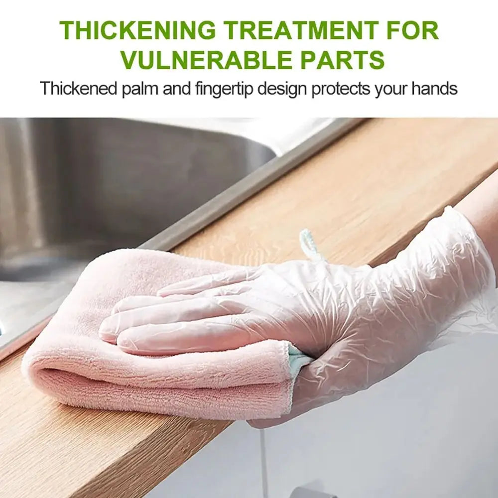 A hand wearing a pink disposable safety glove is protecting a wooden surface with a pink towel.