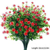Un bouquet de fleurs artificielles d'automne et d'Halloween avec du feuillage rouge et vert.