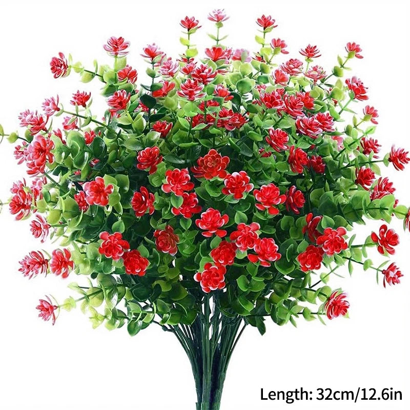 Un bouquet de fleurs artificielles d'automne et d'Halloween avec du feuillage rouge et vert.
