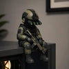 A detailed resin collectible statue of a tactical sniper soldier figurine in olive green armor.