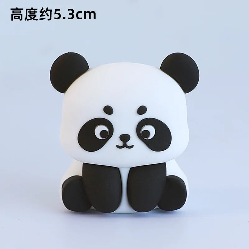 A white and black panda-shaped decoration with large eyes and ears.