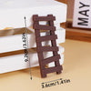 Wooden baby blocks cake toppers featuring bear and car designs stacked on a light wooden surface.