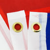 White flag tapestry with brass grommets attached to a red and blue fabric background