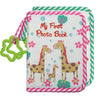 A pink and green striped fabric photo book featuring a giraffe design for a first year baby photo album.