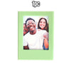 A light green magnetic photo frame displaying a picture of a smiling Black man and a smiling woman.