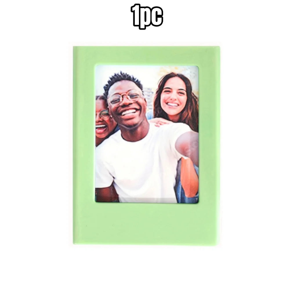 A light green magnetic photo frame displaying a picture of a smiling Black man and a smiling woman.