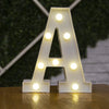 A letter light sign shaped like the letter A with warm white LED lights on a wooden surface.