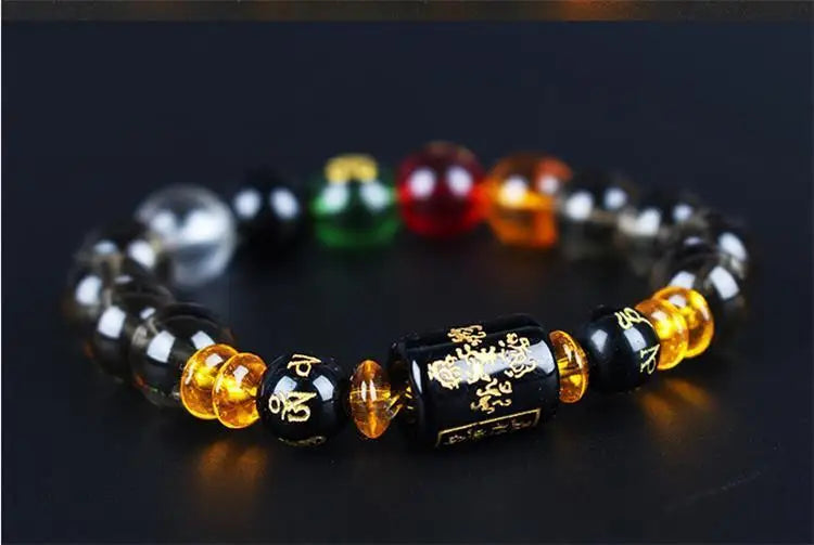 A bracelet made of polished stones in various colors including black, green, red, and amber.