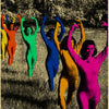 A vintage poster featuring multiple women in brightly colored bodysuits posing dynamically against a dark background.