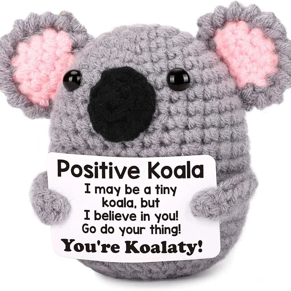 A handmade crochet koala plush toy with pink ears and a card that says You're Koalaty