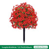 A dense, bright red artificial flower arrangement of petunias on a black ground stake.