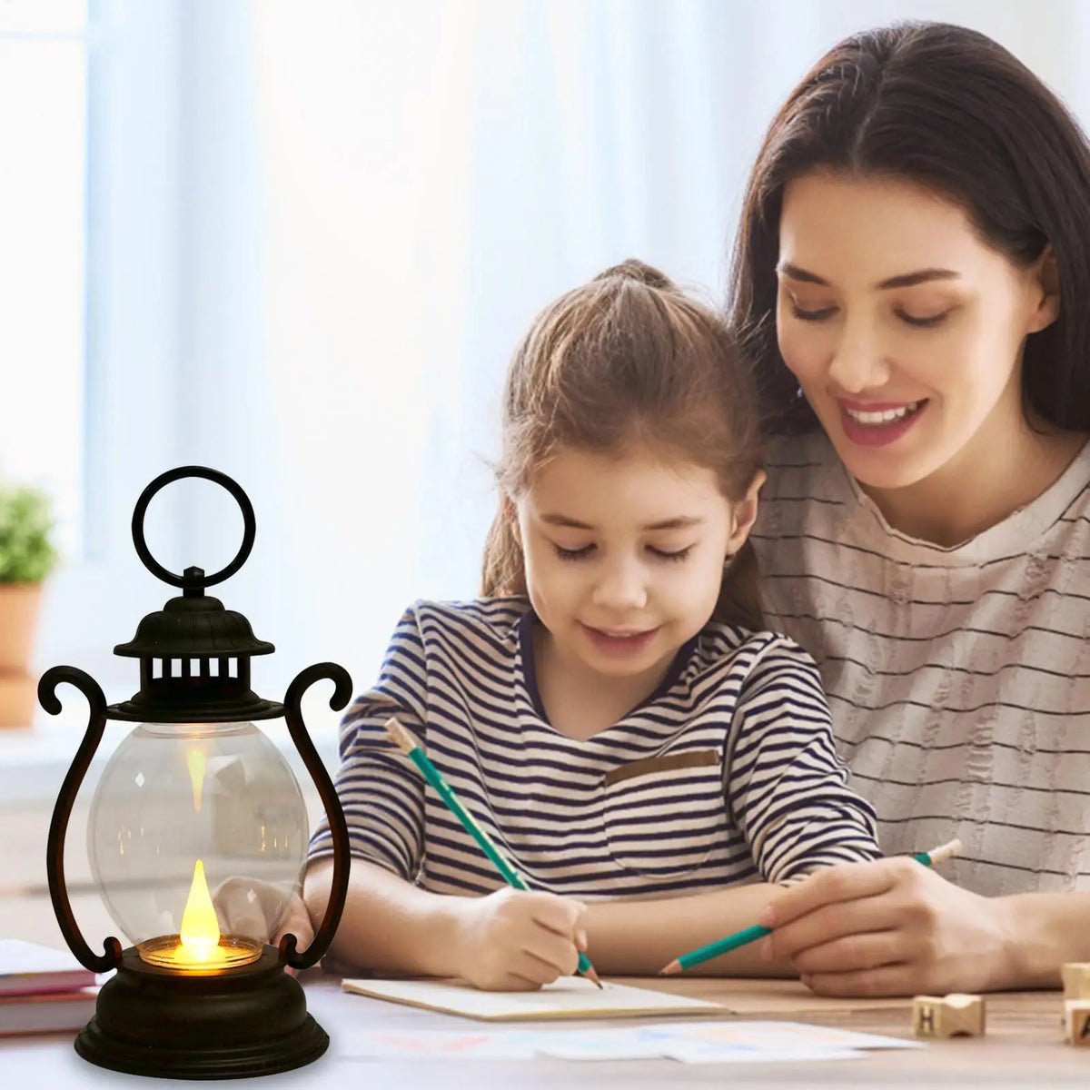 A woman is drawing with a child at a desk using a retro battery-powered desk lamp.