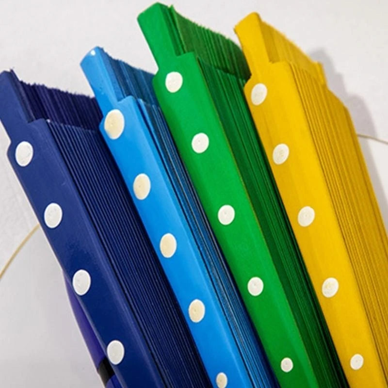 A collection of elegant wooden hand fans in blue, purple, green, and yellow with white polka dots.