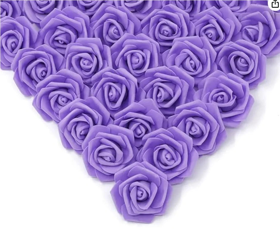 A close-up view of purple artificial foam rose decorations arranged in a heart shape.