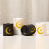 A set of elegant LED star and moon lanterns in black and white are displayed on a white surface.