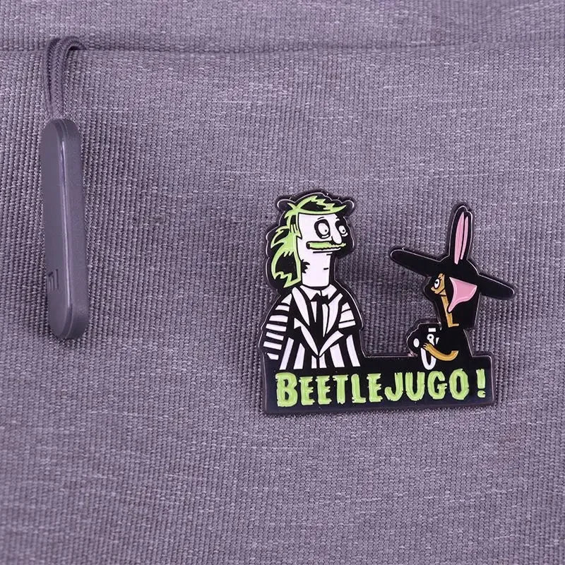 A black enamel pin badge featuring a cartoon character with a large nose and the text BEETLEJUGO.