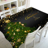 A festive Christmas tablecloth featuring a green tree with gold lights and sparkling stars on a black background.
