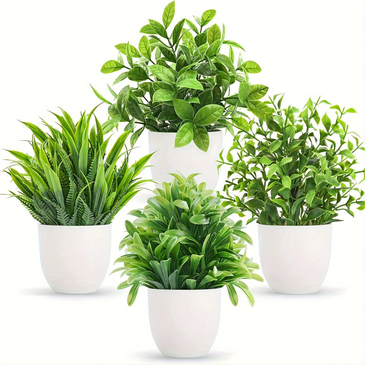 A set of four small artificial bonsai plants in various shades of green potted in white containers.