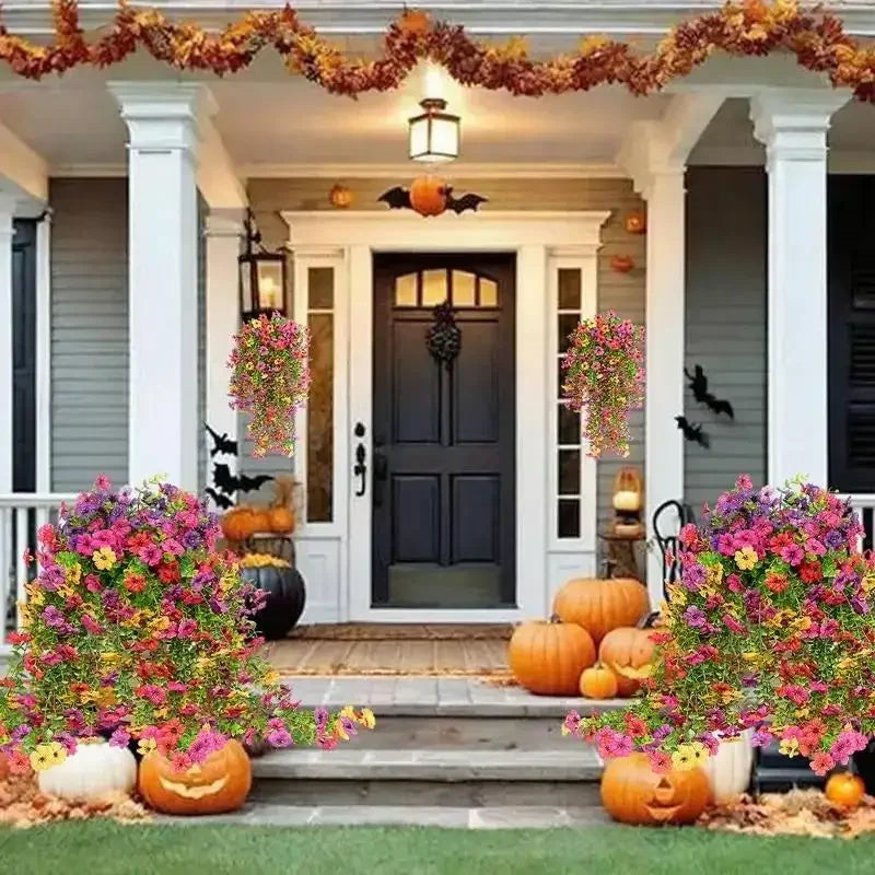 A front porch decorated with autumn foliage and pumpkins, featuring a black door and white columns.