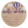 A natural wood birth announcement plaque featuring purple clouds, stars, and a purple hot air balloon design.
