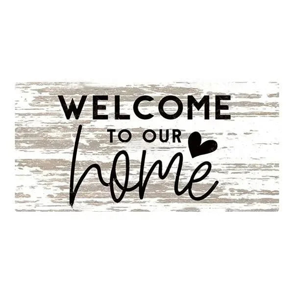 A rustic wooden hanging sign with the text Welcome to our home written in black script on a weathered gray background.