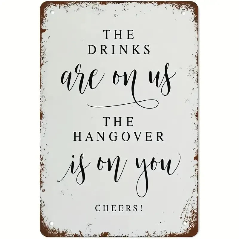A rustic metal tin sign with black script text that reads The drinks are on us the hangover is on you cheers