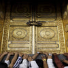 A group of people are reaching towards ornate golden doors decorated with circular patterns, likely a canvas wall art print.