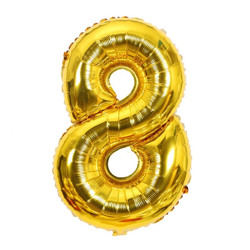 A gold foil number balloon shaped like the number 8.
