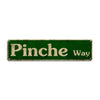 A rectangular green metal sign with the text Pinche way in a distressed font.