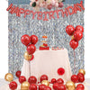 Geburtstags-Hintergrund mit roten und rosa Ballons, Glitzervorhängen und einem Obsttisch.