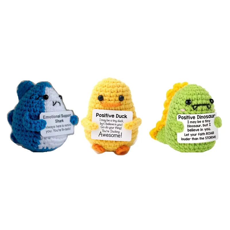 Three handmade plush knitting dolls in blue, yellow, and green with positive affirmations