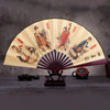 A retro folding silk and bamboo decorative fan with painted scenes of historical figures and landscapes.